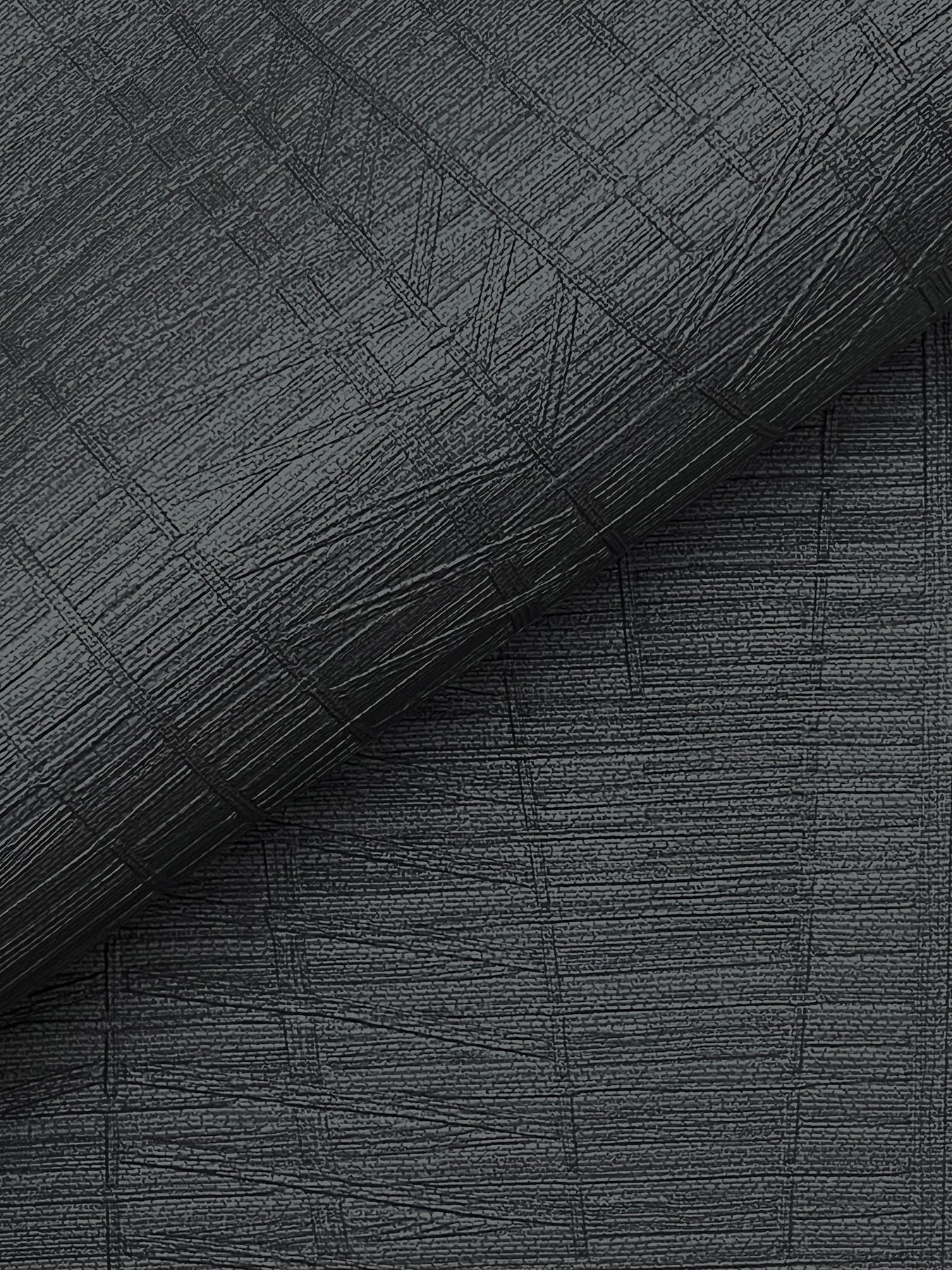 Dark charcoal textured fabric with a crosshatched pattern and rolled edge; upholstery or wallpaper material.