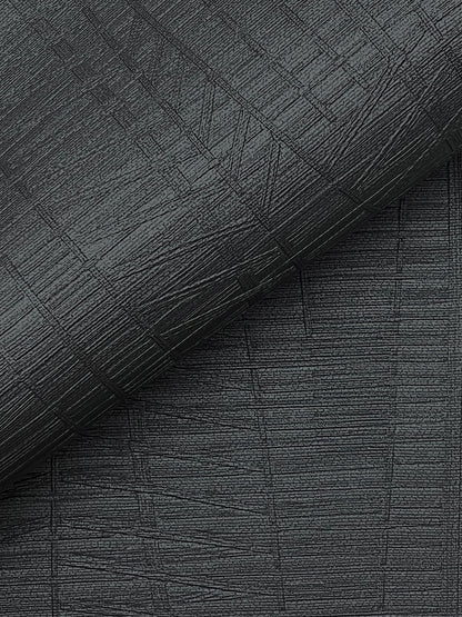 Dark charcoal textured fabric with a crosshatched pattern and rolled edge; upholstery or wallpaper material.