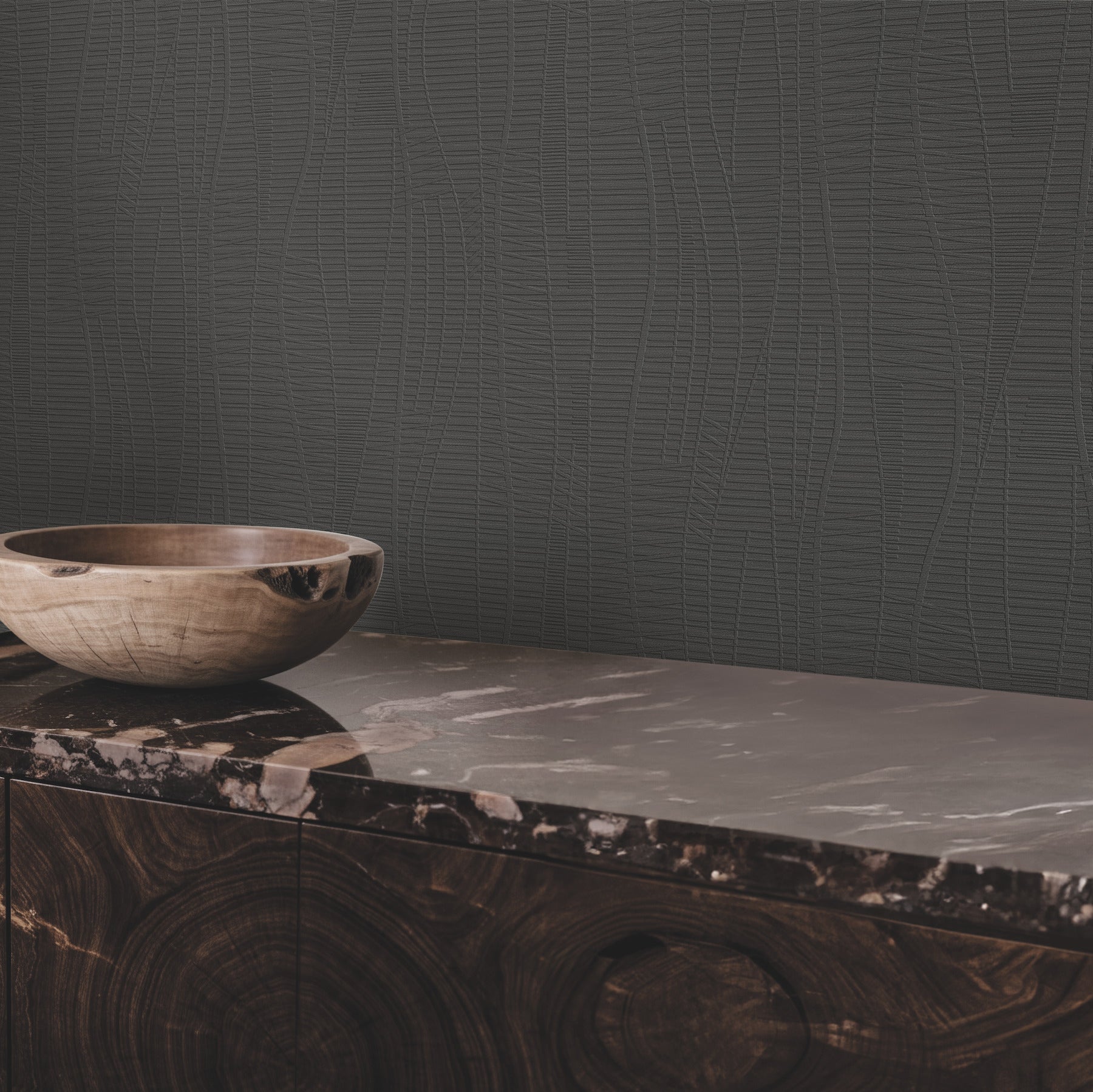 Black embossed wallpaper on a wall in a room, featuring a textured pattern.