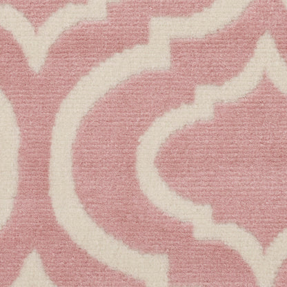 Soft pink rug with ivory scrolling arabesque damask pattern and plush woven texture.