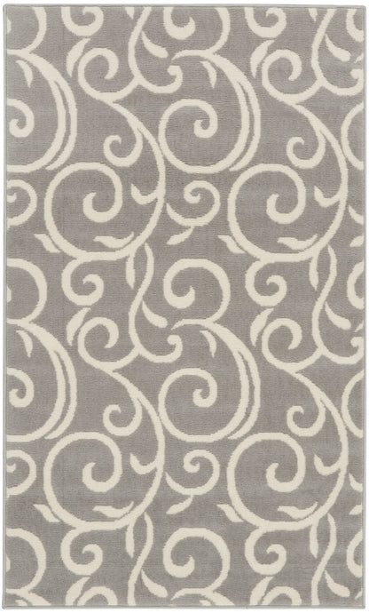 Gray rectangular rug with white scrolling motif, plush texture.