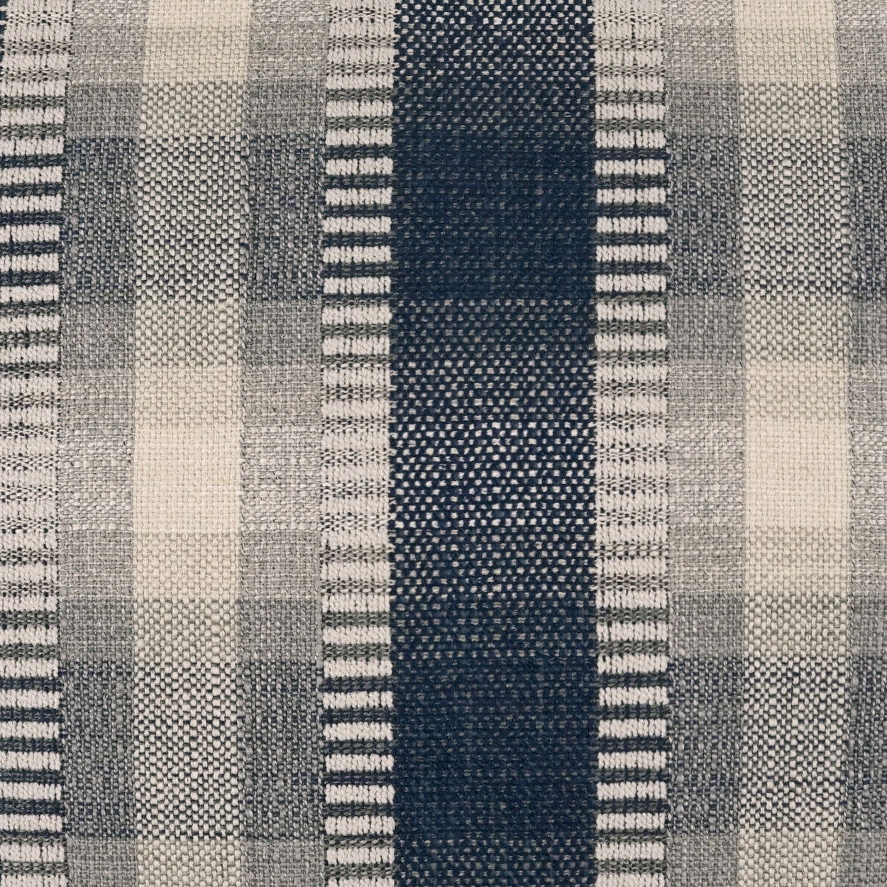 Indigo plaid pillow featuring grey and white plaid with a bold navy center stripe and alternating light-gray bands.