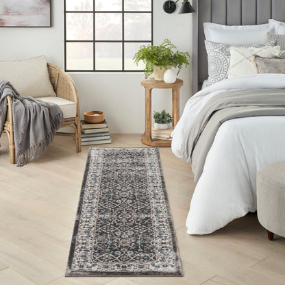 8' long narrow gray oriental-pattern runner rug on light wood floor beside a white bed in a modern neutral bedroom