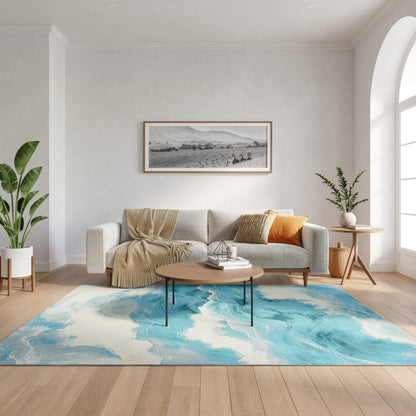 Modern living room with light gray sofa, beige throw, orange pillow, wooden coffee table on a blue abstract rug, plants.