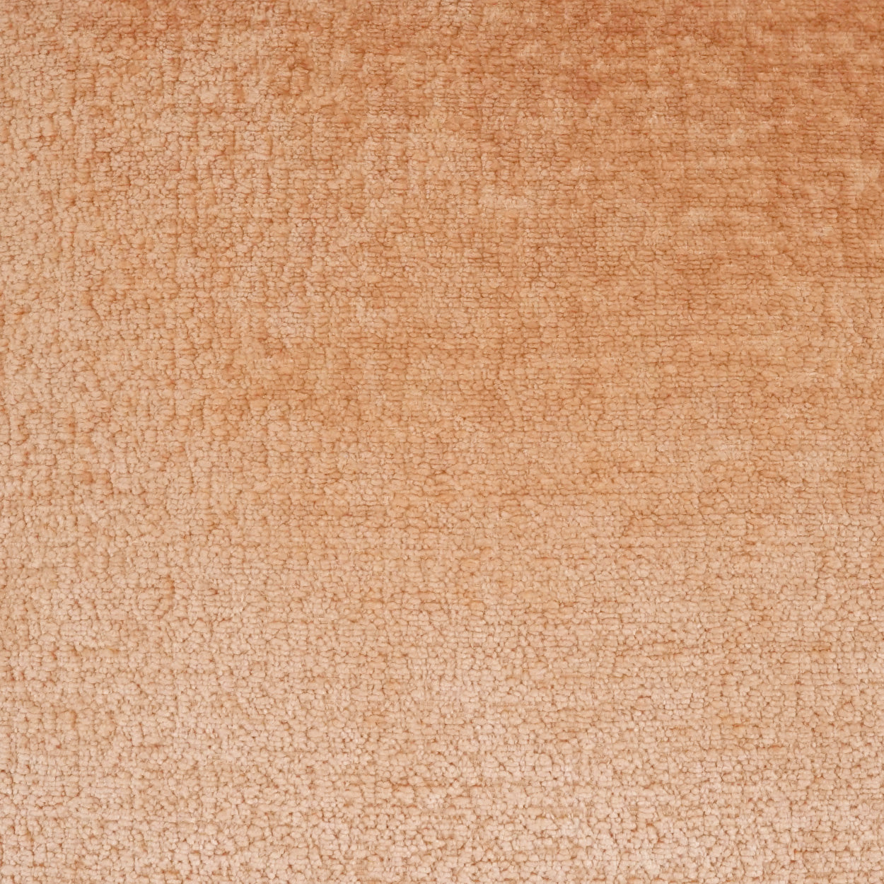 Close-up of blush textured fabric on a pillow with a subtle crackled loop pattern; soft upholstery material.