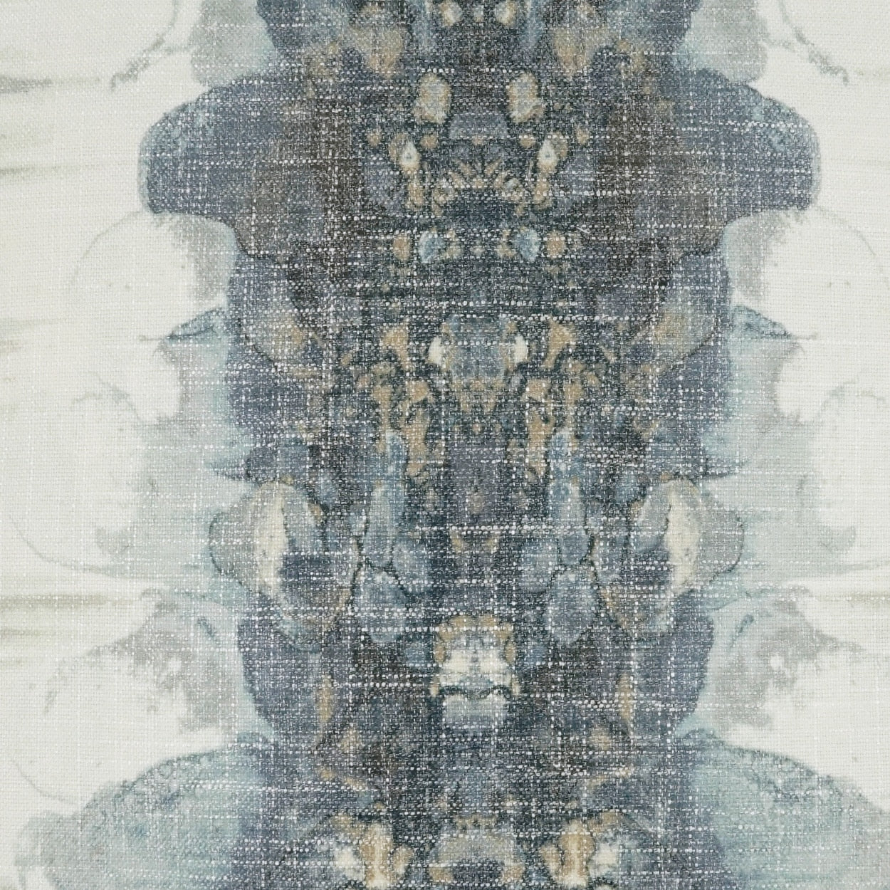 Distressed blue-gray textile with ornate symmetrical beige motif; rug-inspired woven pattern for upholstery or decor.