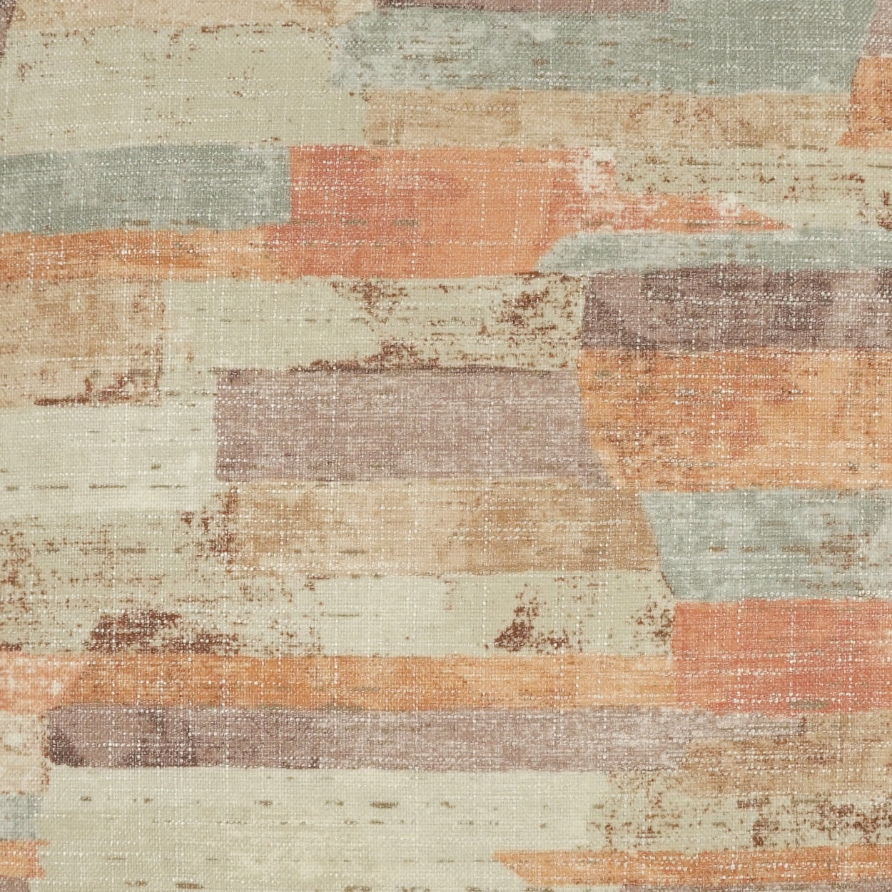 Pastel patchwork rug featuring rectangular blocks in peach, beige, gray, and sage tones with a distressed texture.