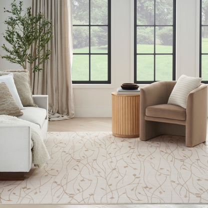Neutral living room: beige armchair, pale sofa, round wooden side table, cream patterned rug, lush plant, grid windows.