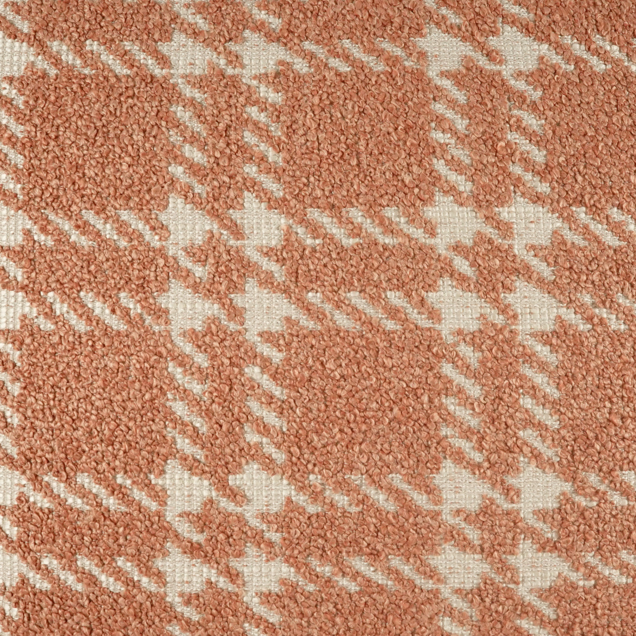 24" x 24" pillow covered in coral-peach boucle with white petal plaid check; soft, textured fabric.