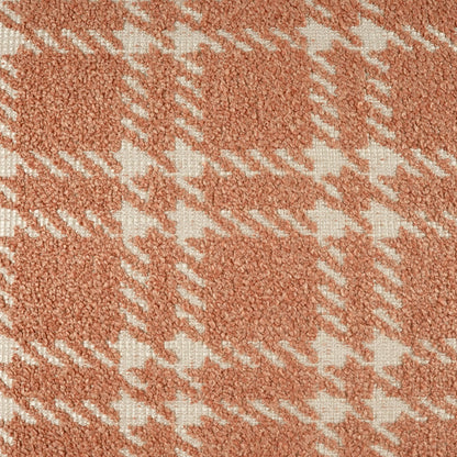 24" x 24" pillow covered in coral-peach boucle with white petal plaid check; soft, textured fabric.