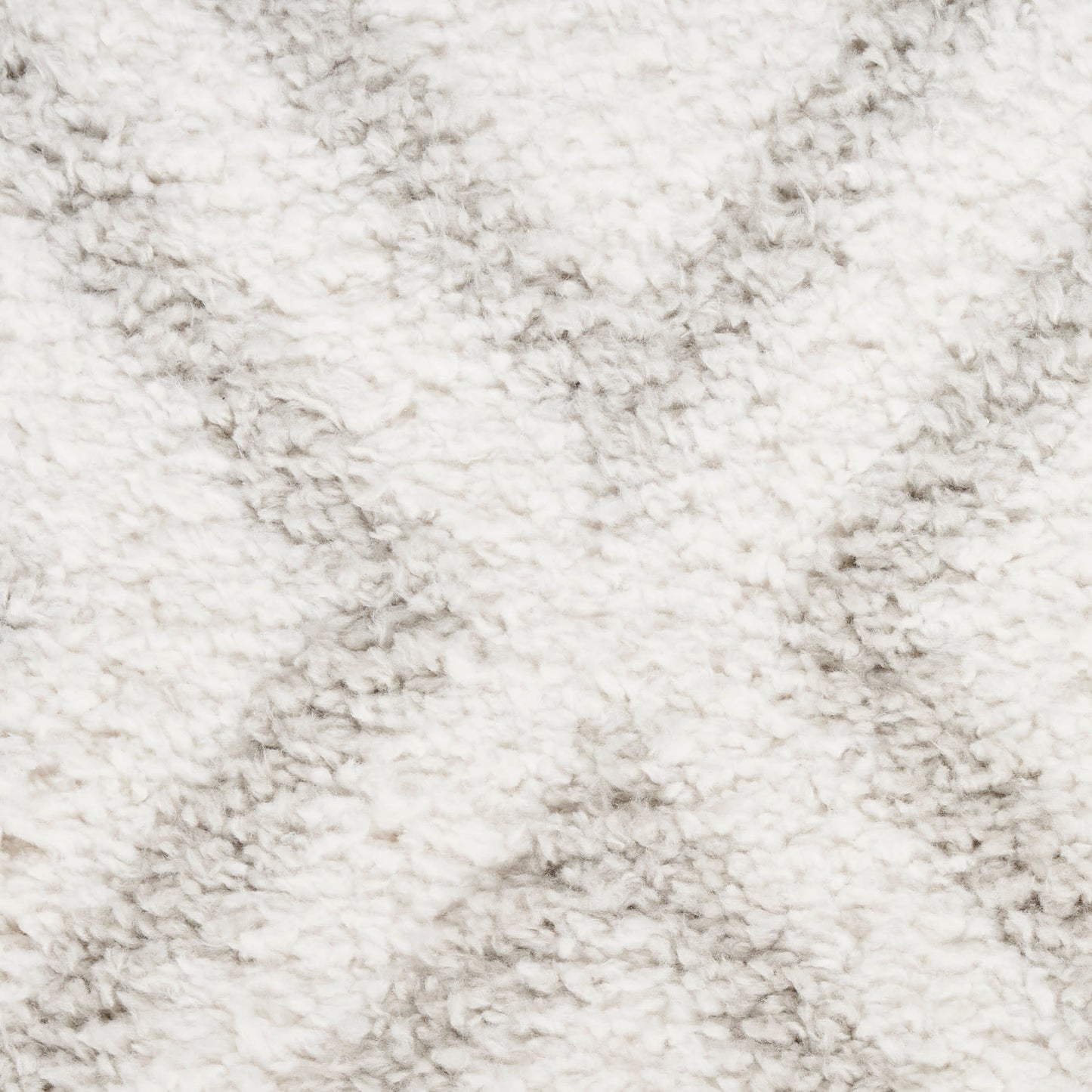 Cream shaggy rug close-up with dense, fluffy pile for cozy decor.