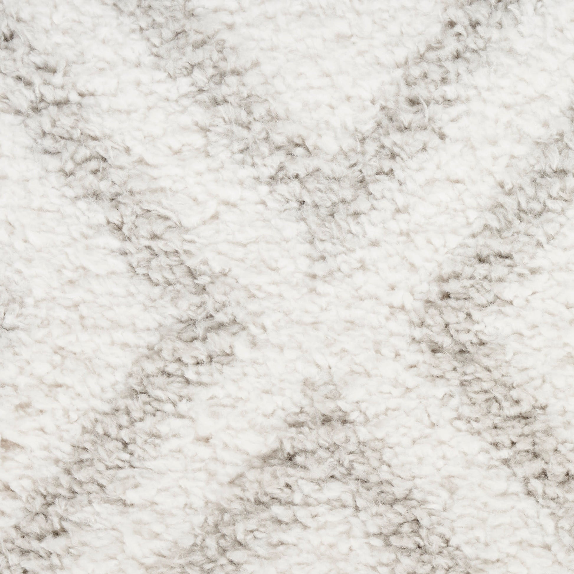 Cream shaggy rug close-up with dense, fluffy pile for cozy decor.