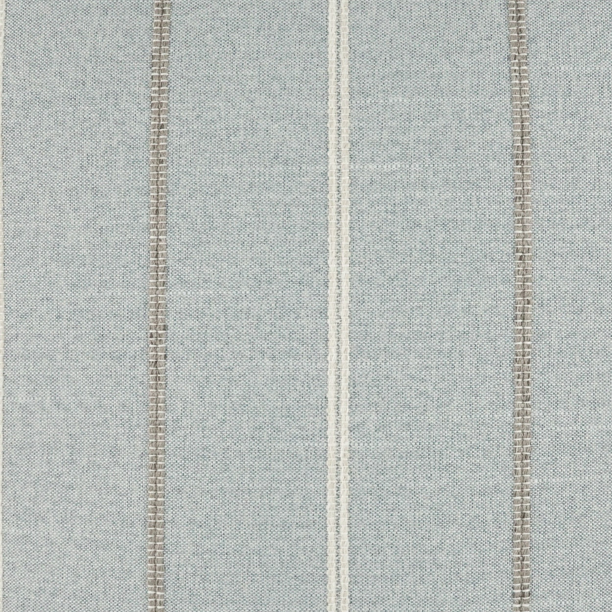 Blue-gray striped woven fabric with white center stripe and brown accents; linen-like texture for upholstery or drapery.