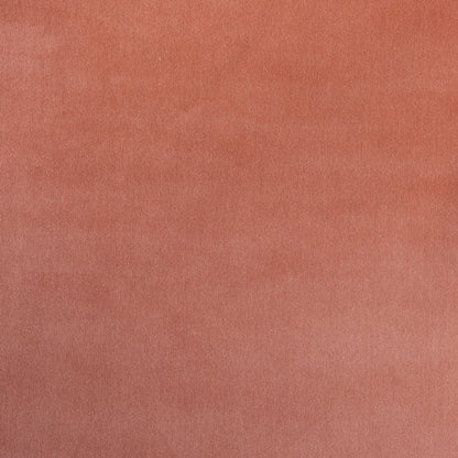 Soft peach-pink fabric texture in close-up with a smooth matte finish, ideal for apparel or upholstery.