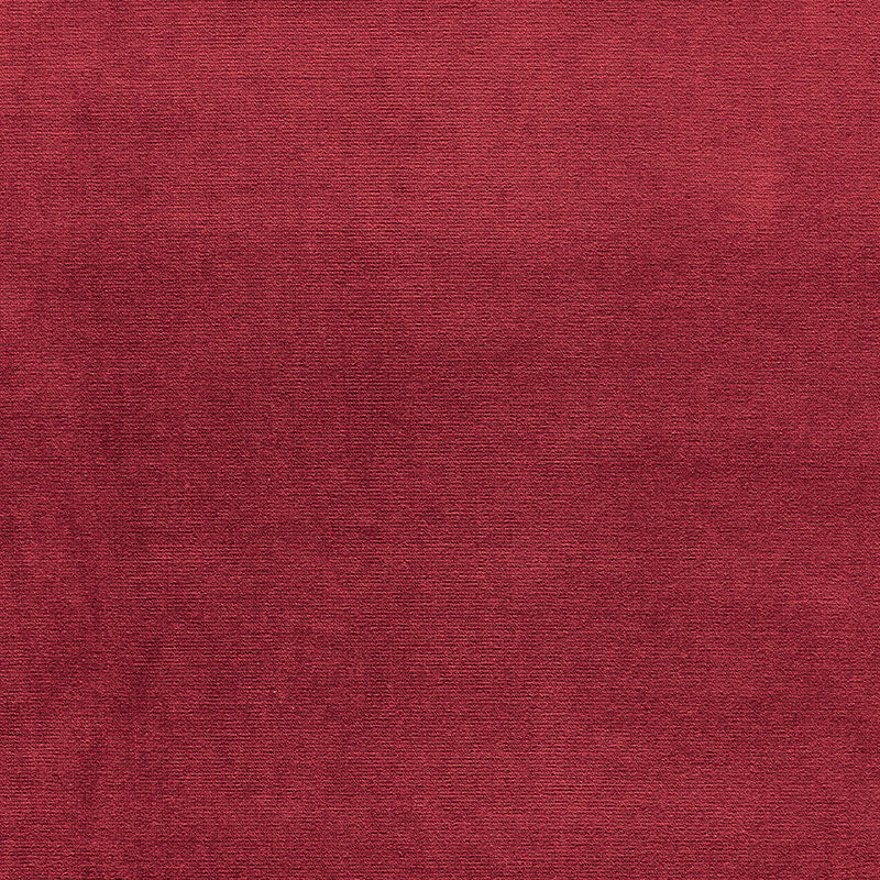 Deep red velvet fabric texture with soft nap and rich color.