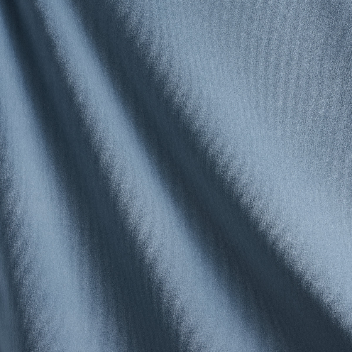 Light blue velvet with soft drape, subtle diagonal shadows and a smooth matte texture.