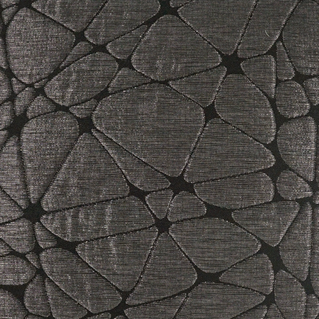 Charcoal gray fabric with irregular pebble-like rock mosaic pattern; textured upholstery material.