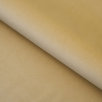 Beige fabric swatch with a diagonal fold and rolled edge; soft, smooth textile suitable for upholstery or crafts.