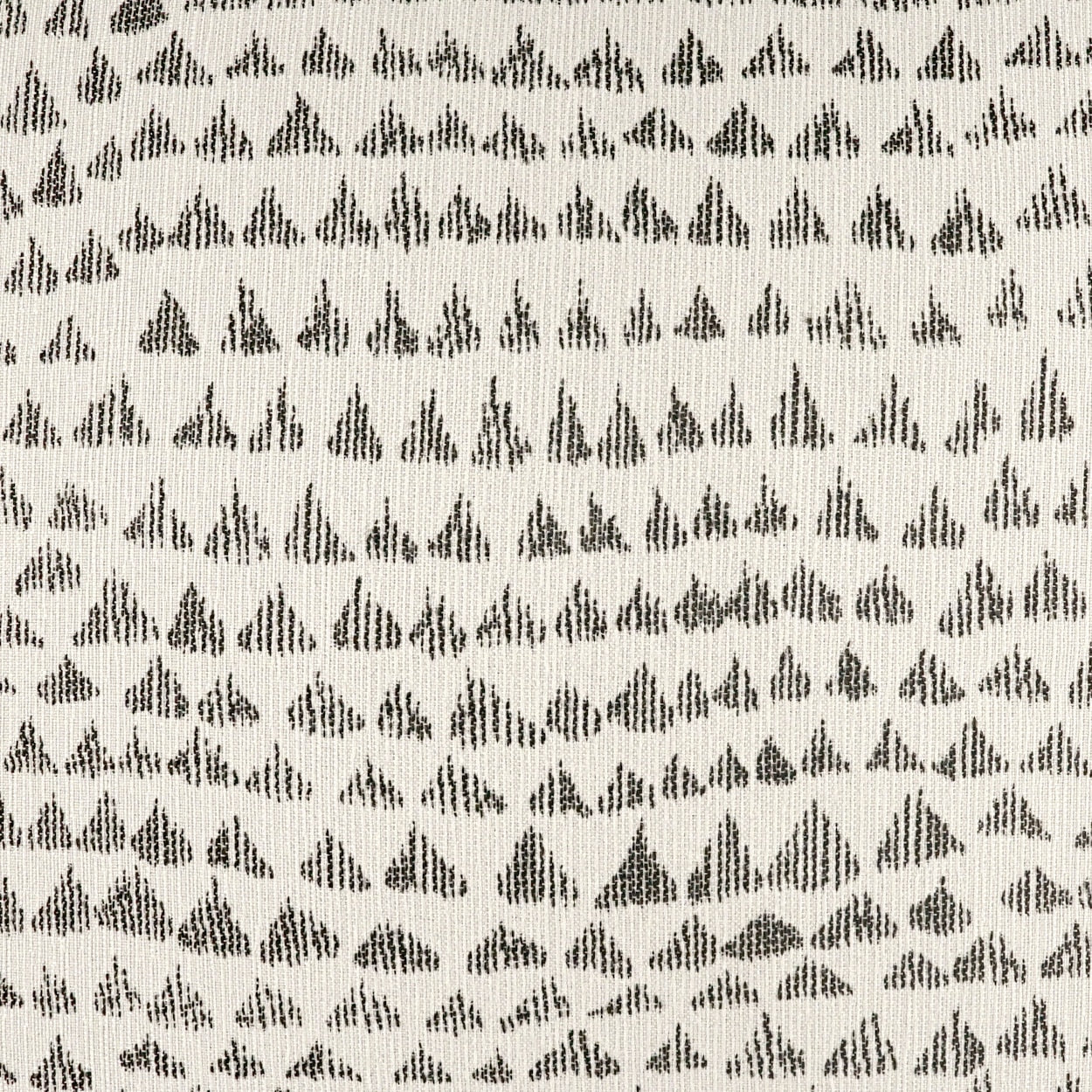 Beige woven fabric with small black geometric teardrop/diamond motifs arranged in neat rows.