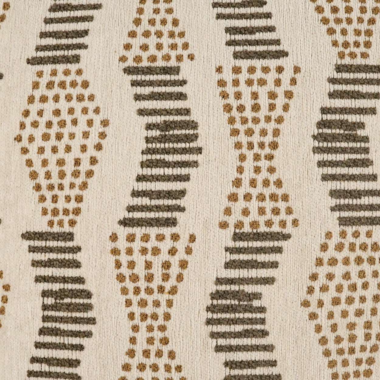 Beige fabric with vertical repeating oval shapes made of brown dots and dark gray horizontal bars.