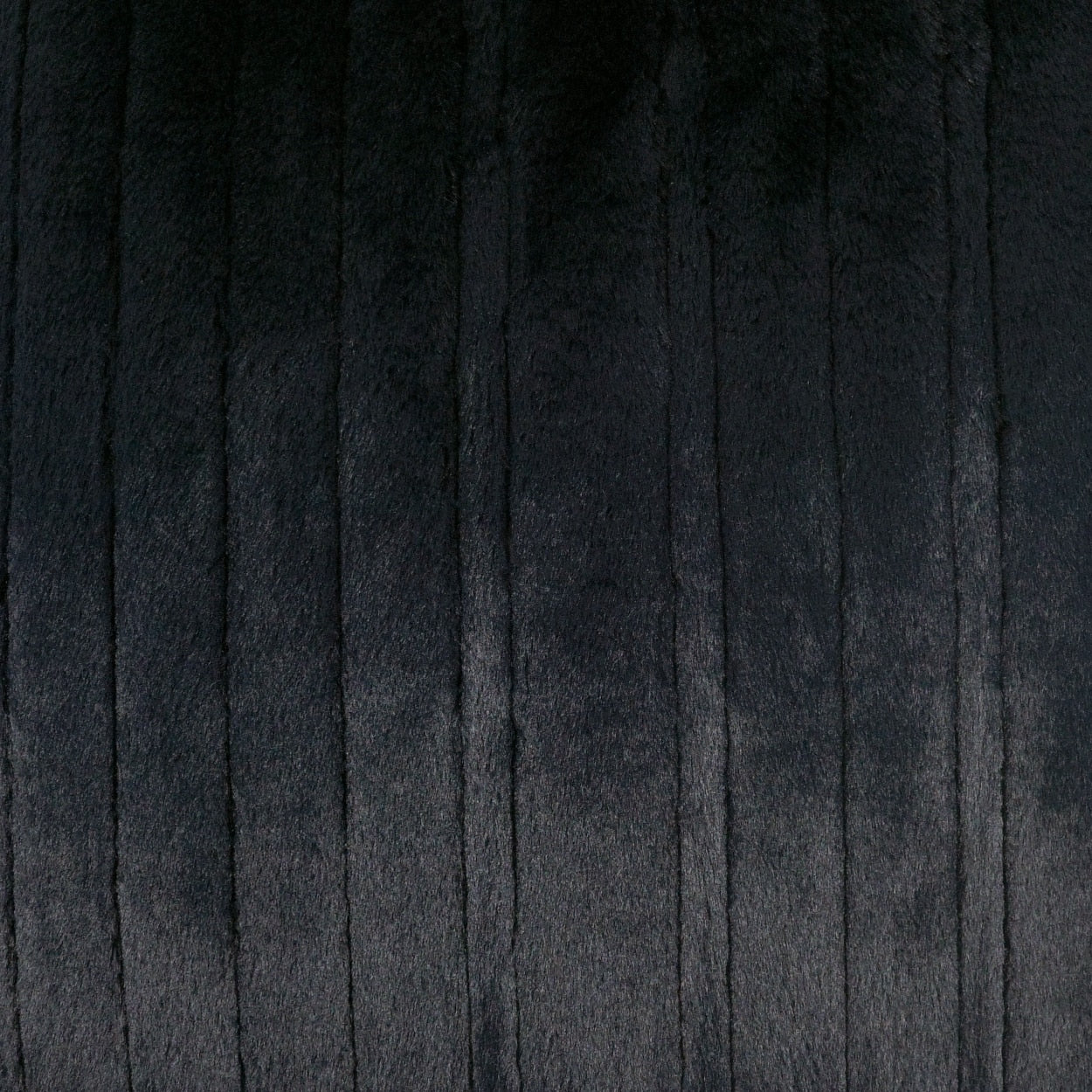 Close-up of dark charcoal corduroy fabric with vertical ridges and soft texture.