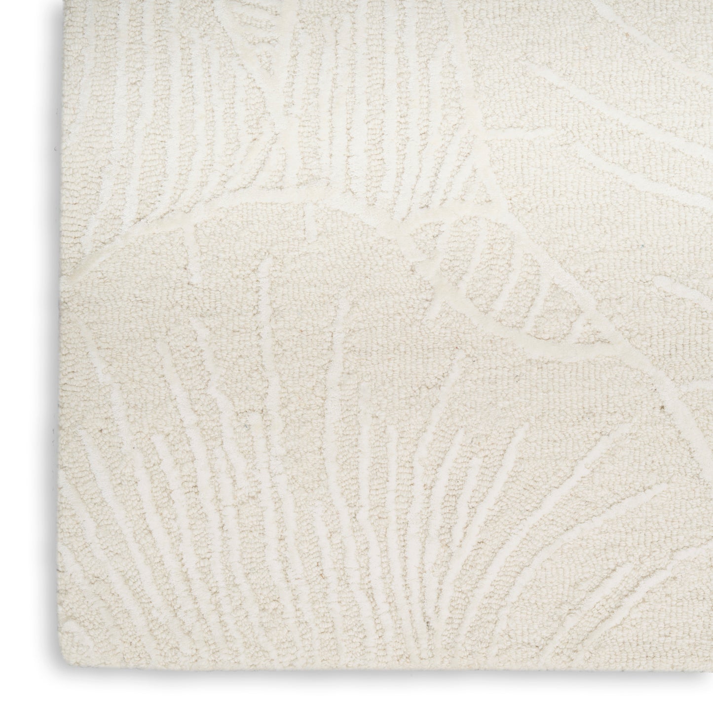 Cream textured rug with raised botanical leaf pattern; plush pile, rectangular, ideal for living room decor.