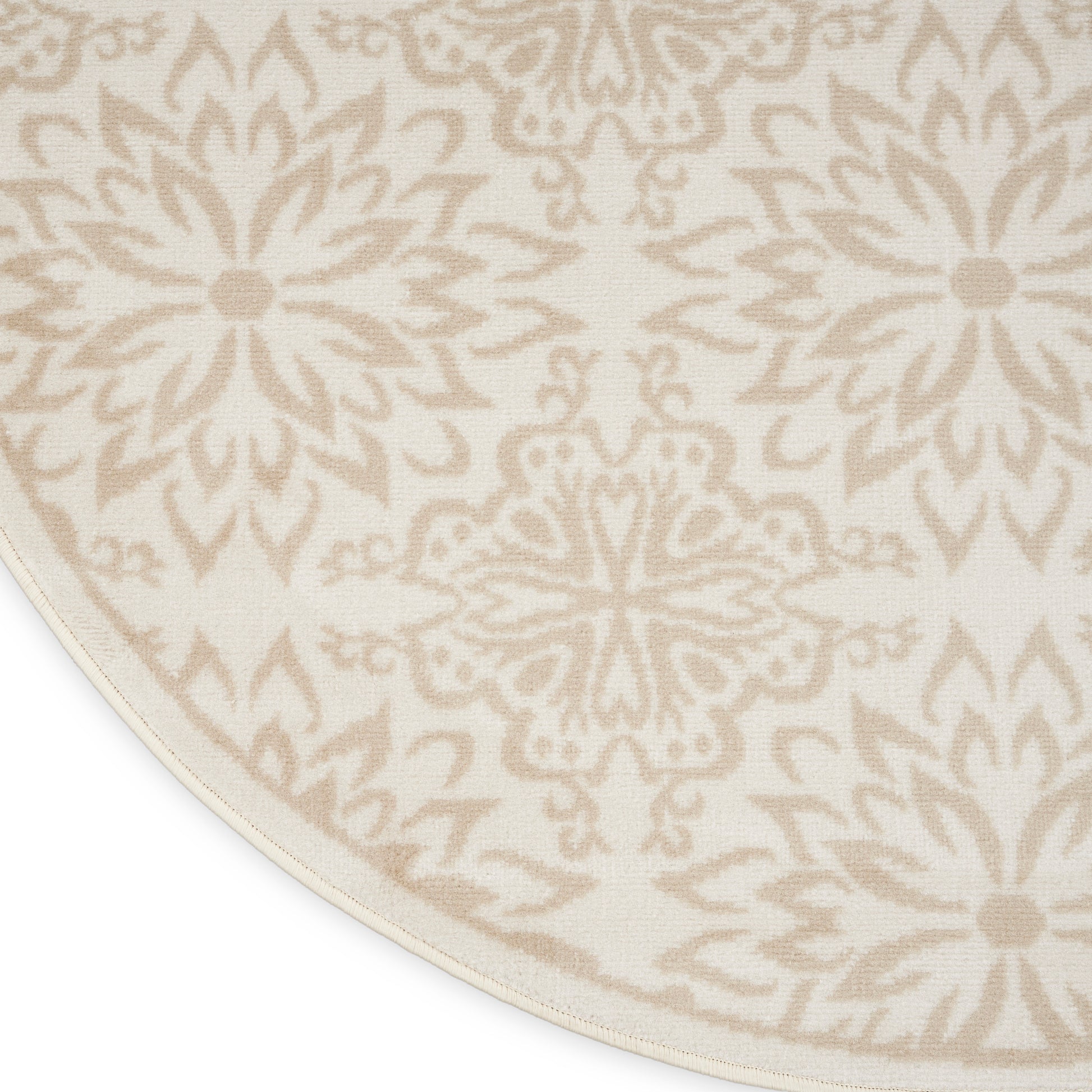 Round cream rug with beige ornate medallion pattern; woven textile in warm neutral tones.