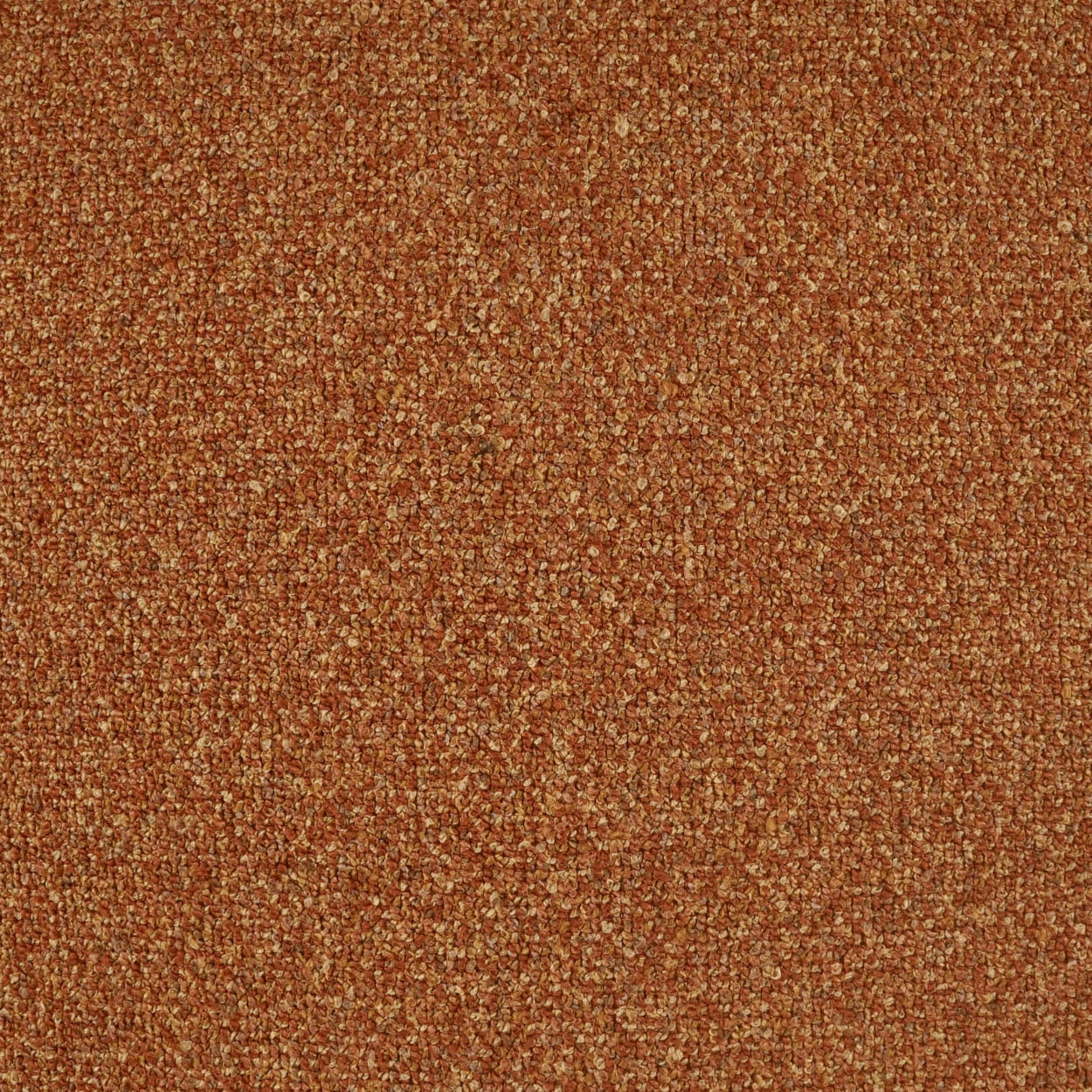 Rust-brown textured fabric close-up with a looped, pebble-like surface for upholstery or carpeting