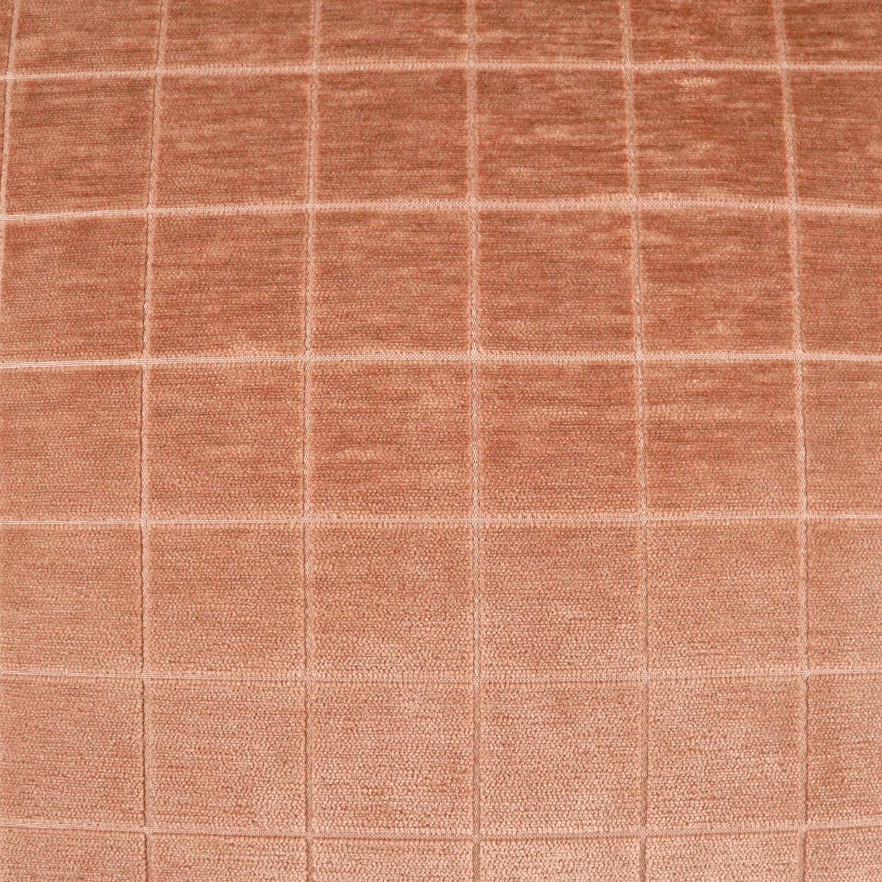 Peach-colored fabric with stitched square grid pattern; soft, plush texture.
