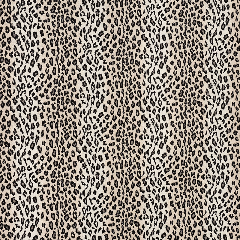 Beige snow leopard print fabric pattern with irregular dark spots; bold animal-print textile for clothing or accessories.