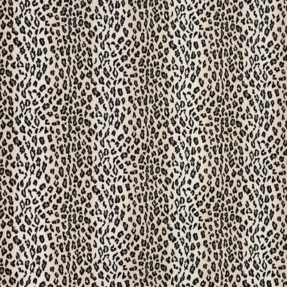Beige snow leopard print fabric pattern with irregular dark spots; bold animal-print textile for clothing or accessories.