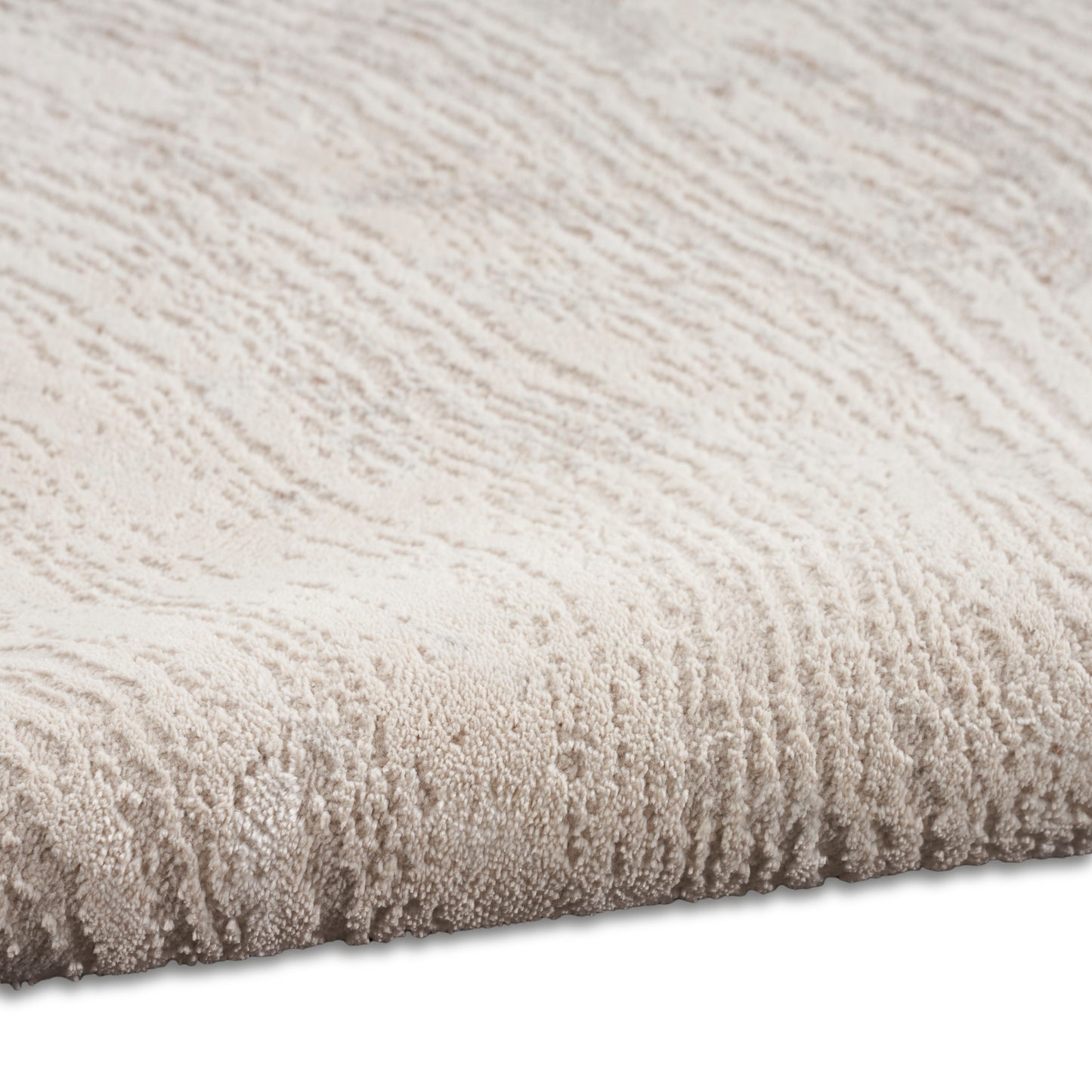 Beige plush rug with textured wavy pile; cozy, modern decor accent.