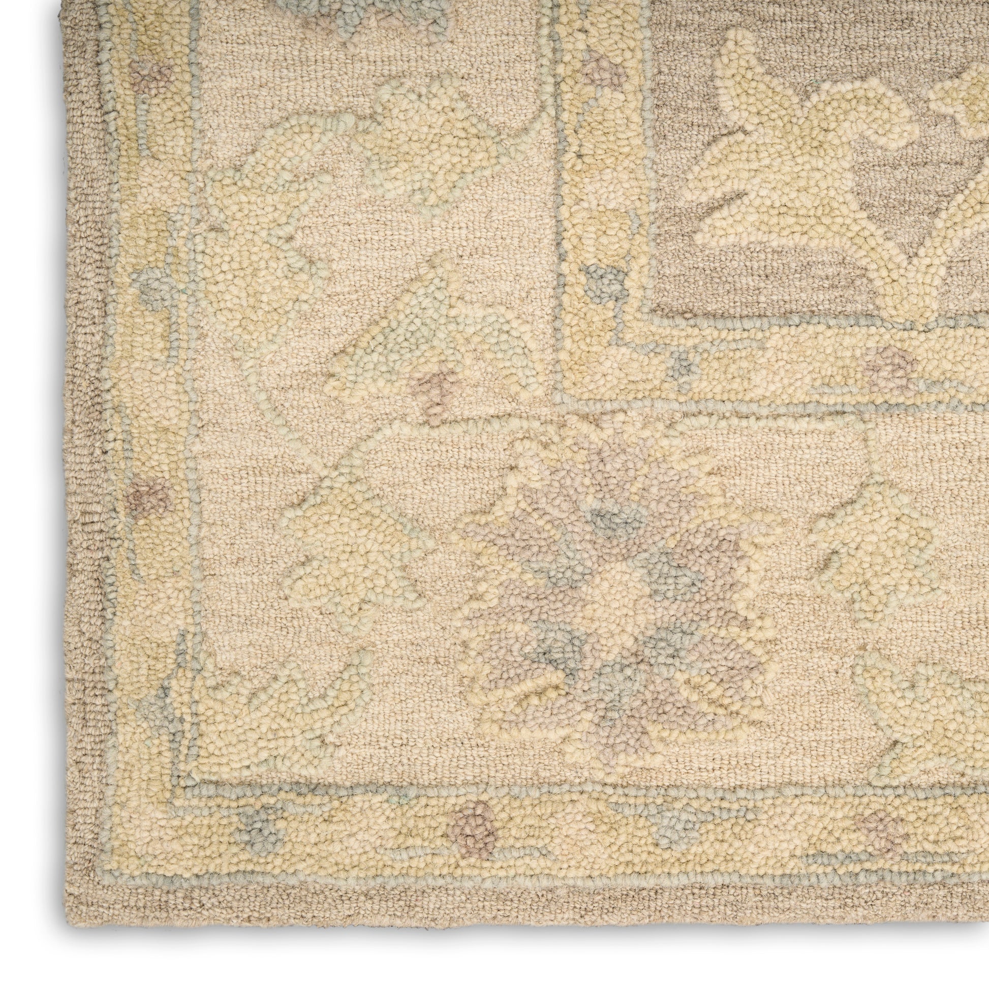 Soft pastel beige Oriental rug corner with pale blue and lavender florals, intricate border, woven texture, medium pile