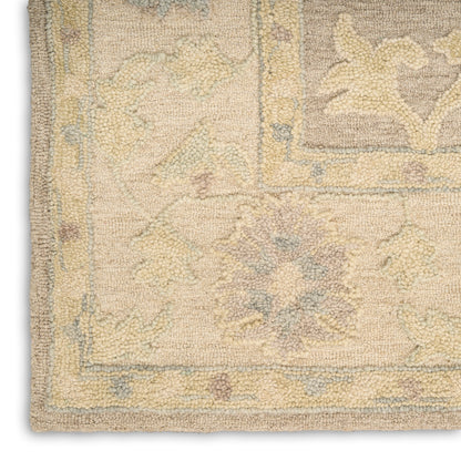 Soft pastel beige Oriental rug corner with pale blue and lavender florals, intricate border, woven texture, medium pile
