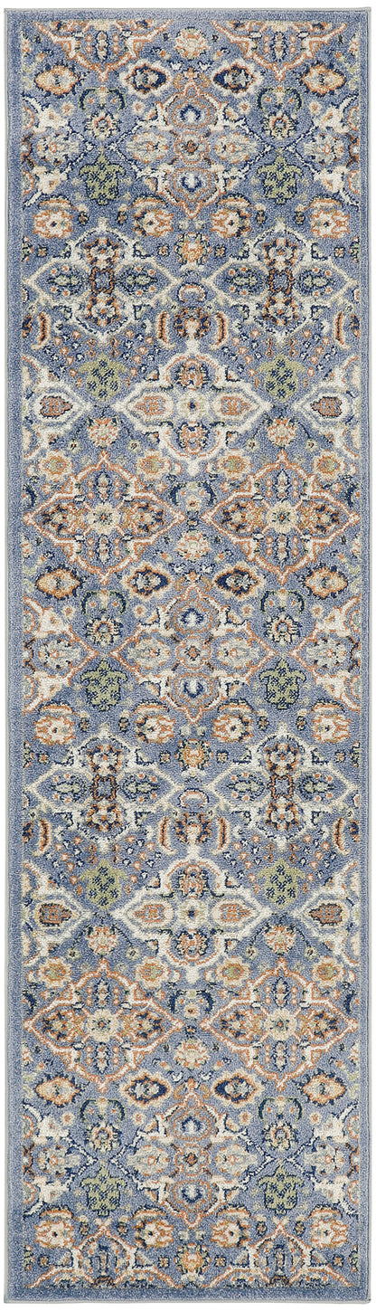 Blue oriental runner rug with intricate ivory, orange, and sage floral medallions; long narrow design.