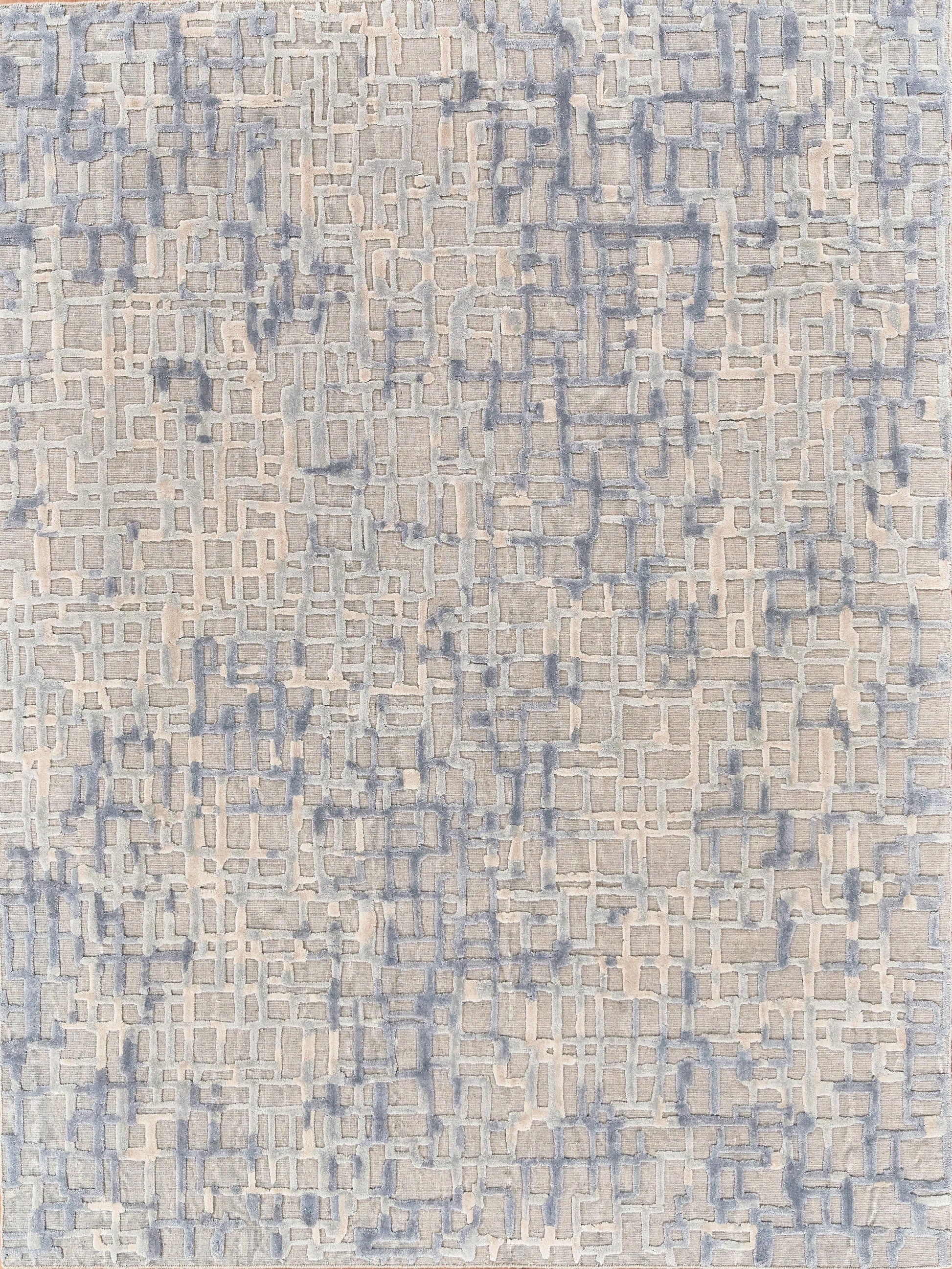 Beige rug with blue-gray interlocking rectangle pattern and raised pale white accents.