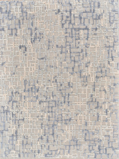 Beige rug with blue-gray interlocking rectangle pattern and raised pale white accents.