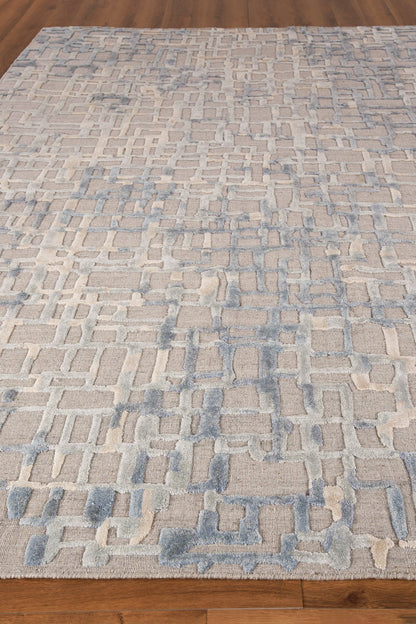 Soft, modern rug with beige base and light blue geometric lattice blocks on a wooden floor.