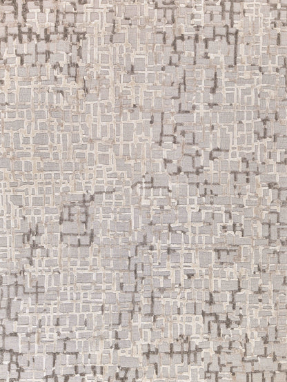 Neutral-toned rug with abstract beige and taupe mosaic grid, textured weave for modern living room decor.