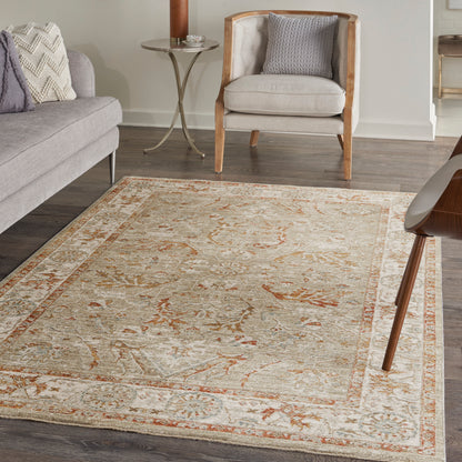 Soft beige oriental-style area rug with orange floral motifs and pale blue borders in a modern living room.