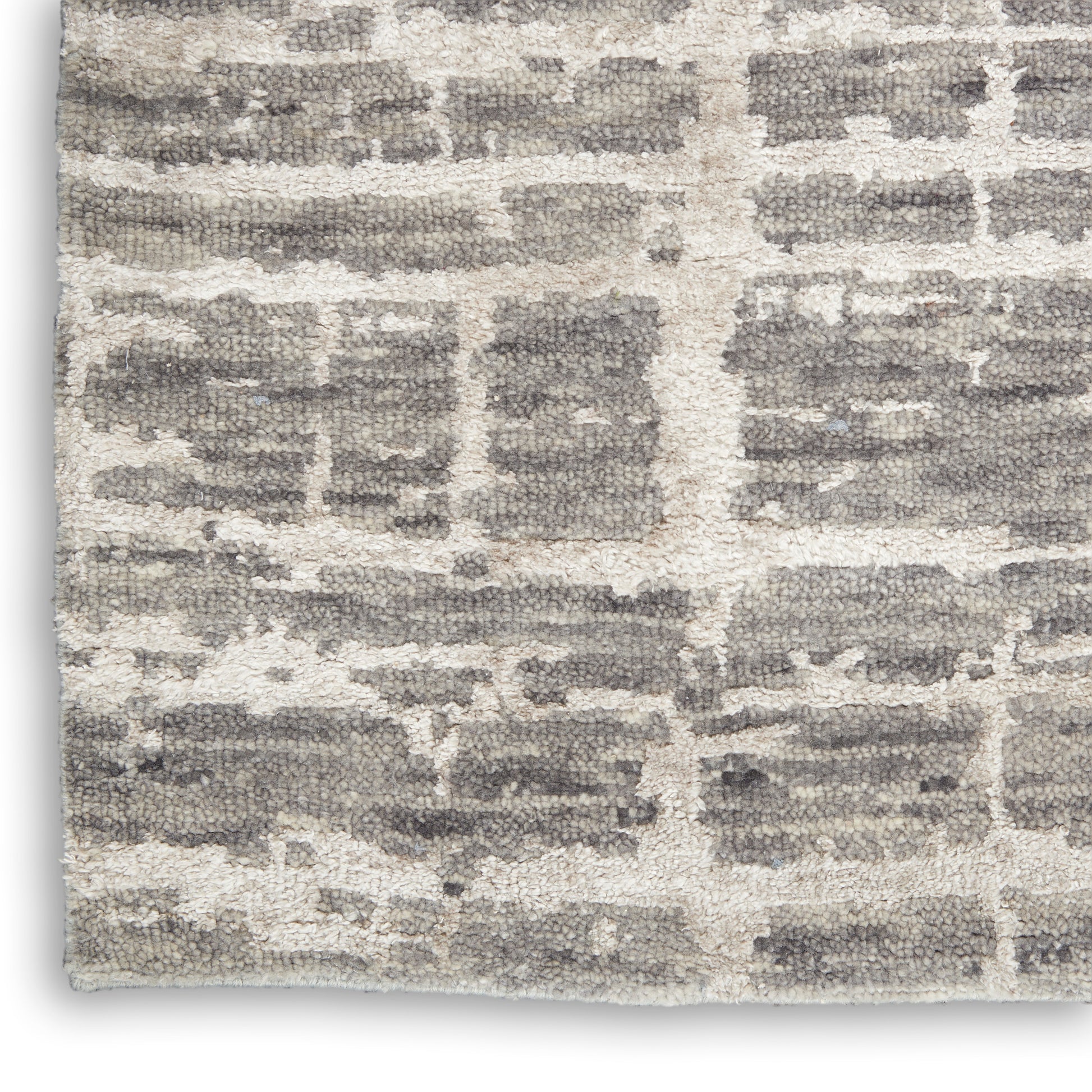 Beige rug with gray brick-pattern blocks and a plush, textured pile; modern rustic living room style.