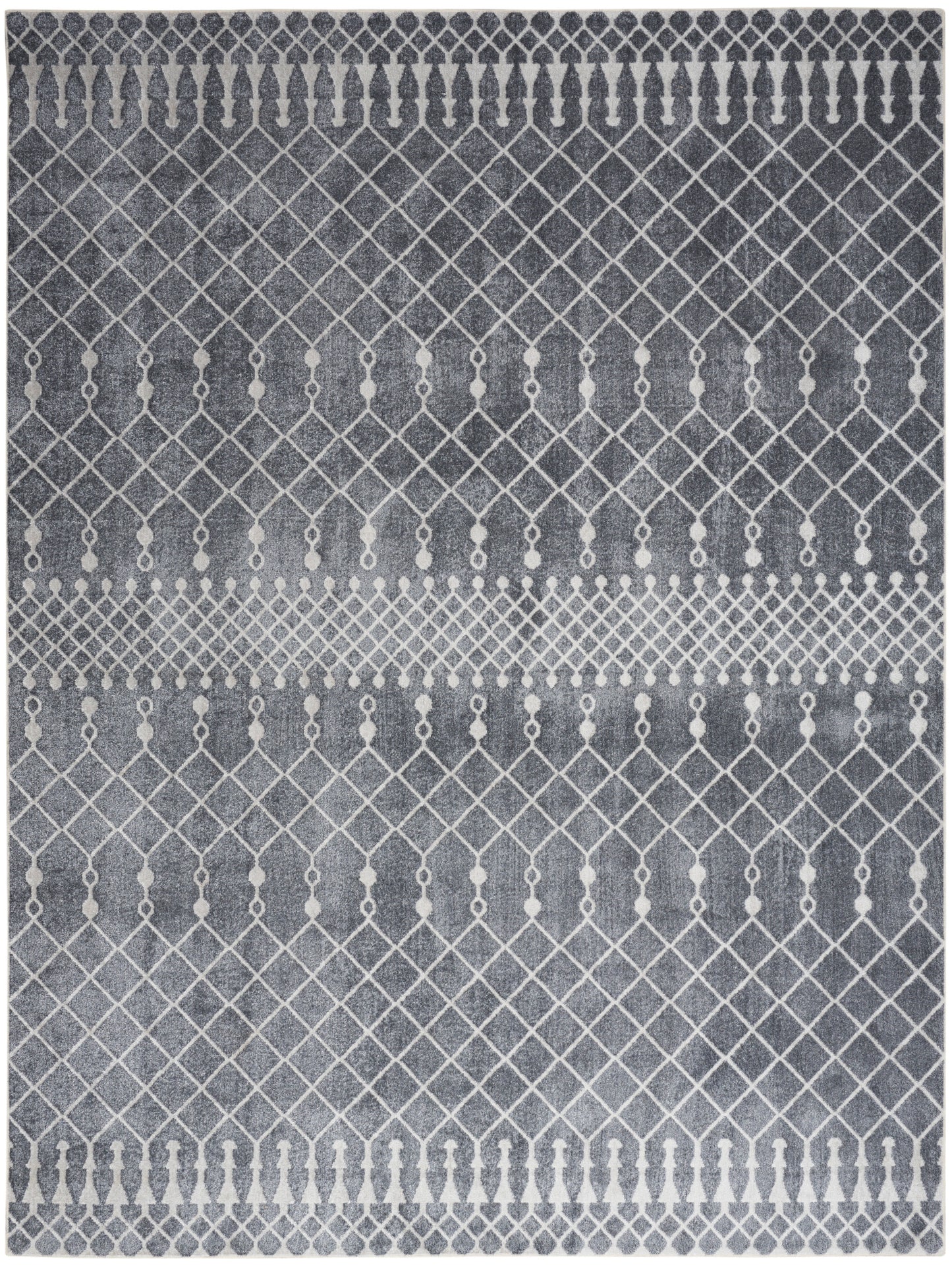 Grey-blue rug with white diamond lattice motif and small circular accents; geometric, modern boho-style.
