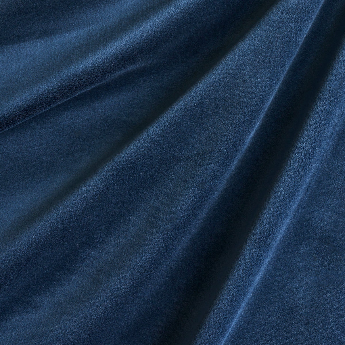 Navy blue velvet fabric with soft nap and flowing folds.