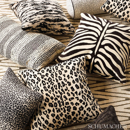 Assorted animal-print throw pillows in beige, tan and black with zebra stripes, leopard spots and snakeskin patterns.