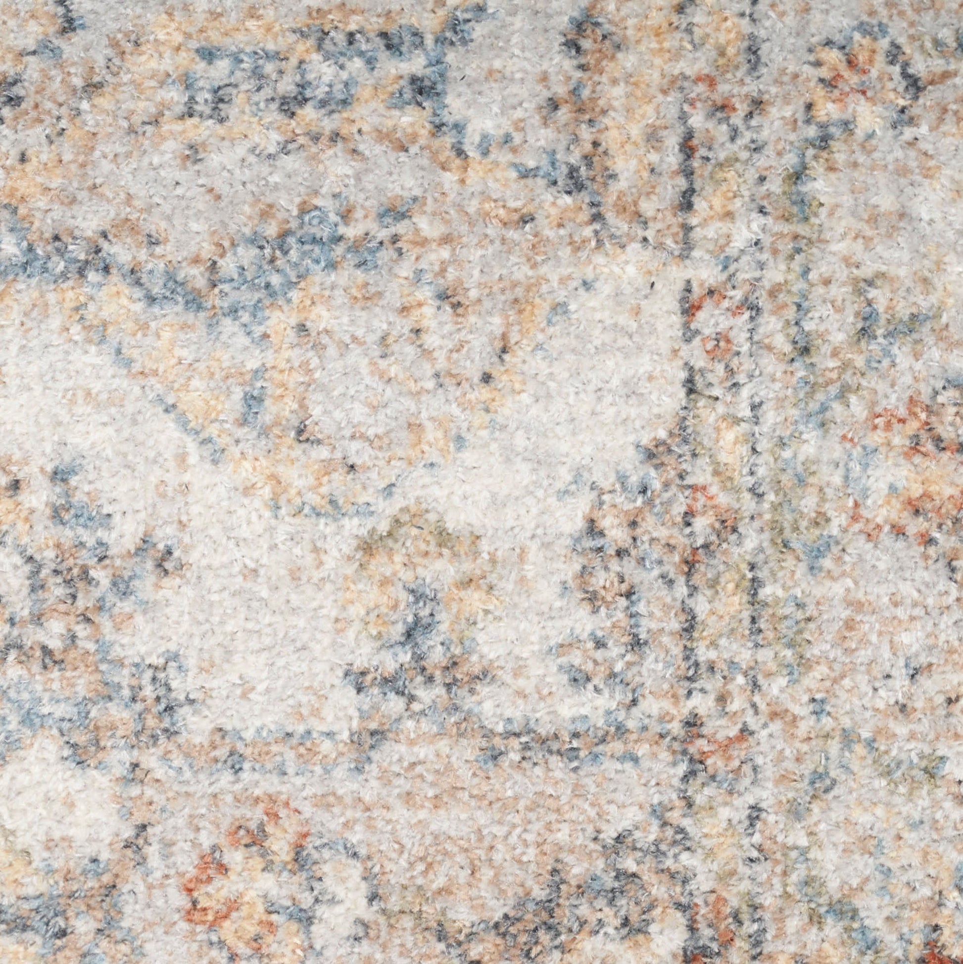 Close-up of a plush, high-pile rug with abstract beige, ivory, blue-gray and rust motifs.