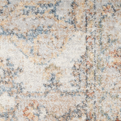 Close-up of a plush, high-pile rug with abstract beige, ivory, blue-gray and rust motifs.