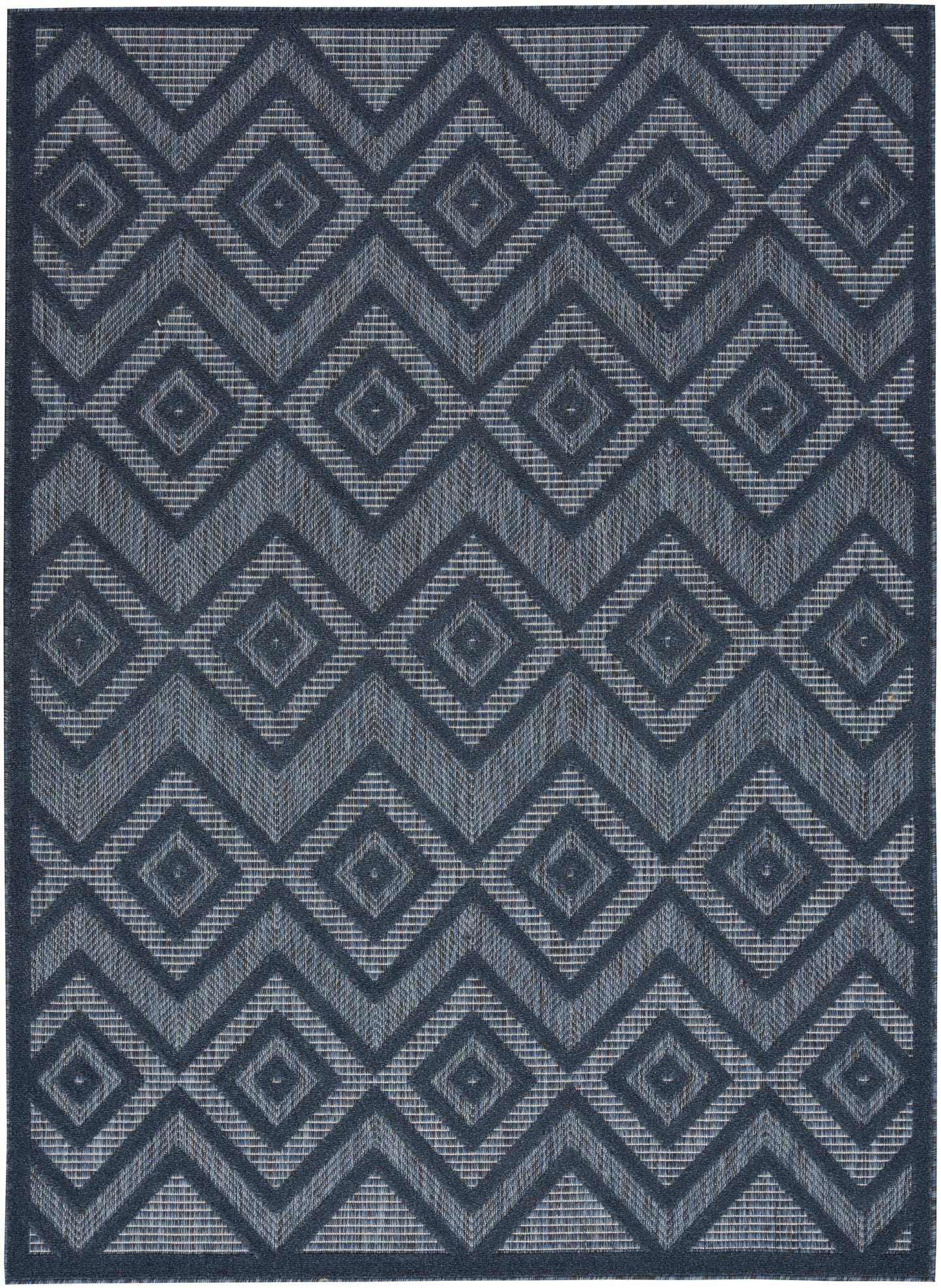 Navy and gray geometric rug with interlocking diamonds and chevrons; woven texture.