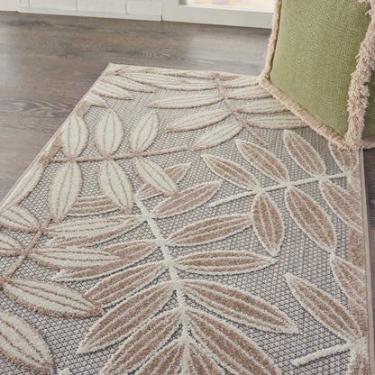 Neutral-toned area rug with beige leaf motif, woven texture on gray background; modern botanical style.