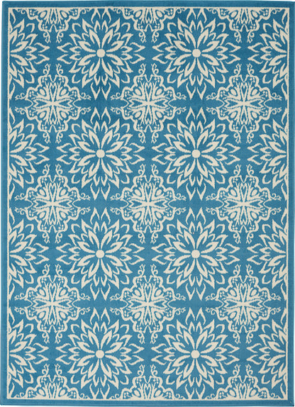 Teal-blue area rug with repeating white starburst floral medallions; rectangular with border.
