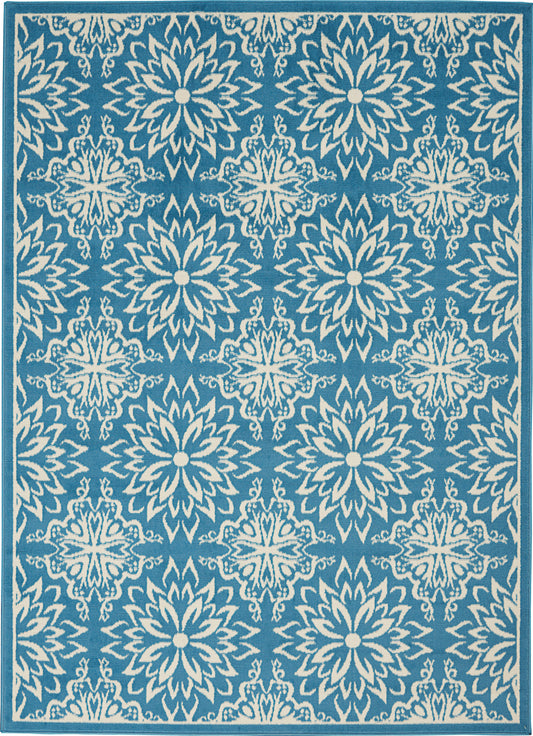 Teal-blue area rug with repeating white starburst floral medallions; rectangular with border.